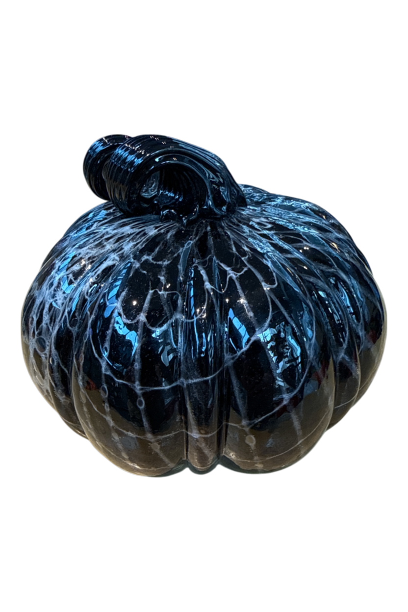 A decorative glass pumpkin with a glossy black body and vibrant blue and white marbled patterns, set against a plain white background.