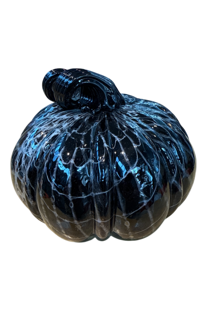 A decorative glass pumpkin with a glossy black body and vibrant blue and white marbled patterns, set against a plain white background.